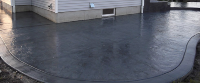 Stained concrete patio with stamped concrete edging.
