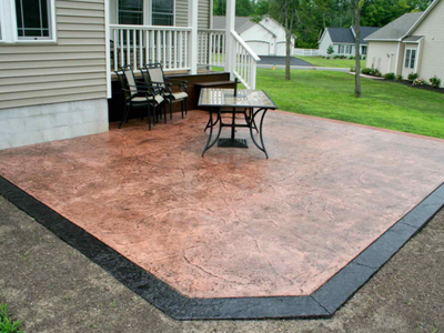 Textured concrete patio with dark stained border.