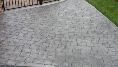 Old style stone stamped concrete driveway.