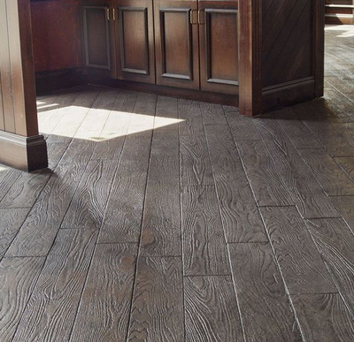 Wood plank designed stamped concrete kitchen floor.