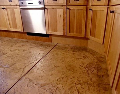 Kitchen floor made out of textured and stained concrete.