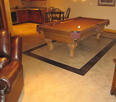 Decorative concrete floor in a downstairs game room.