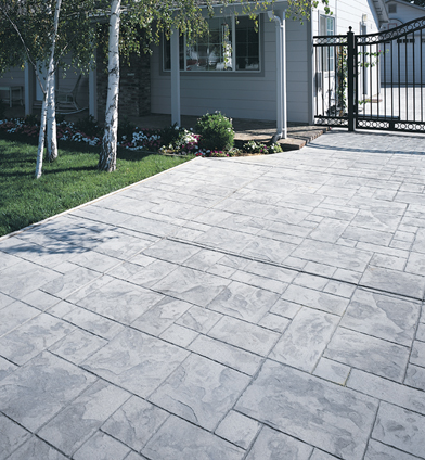 Front yard stamped concrete patio with gray paver design.