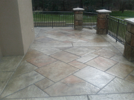 Concrete front porch with stamped concrete shaped as ceramic tile.